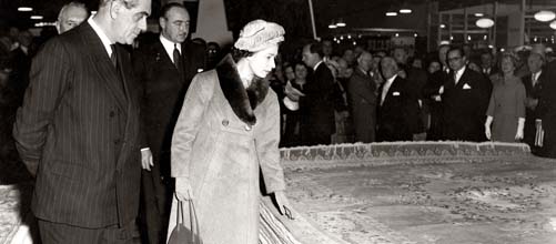 Her Majesty Queen Elizabeth II admires an OBEETEE rug.
